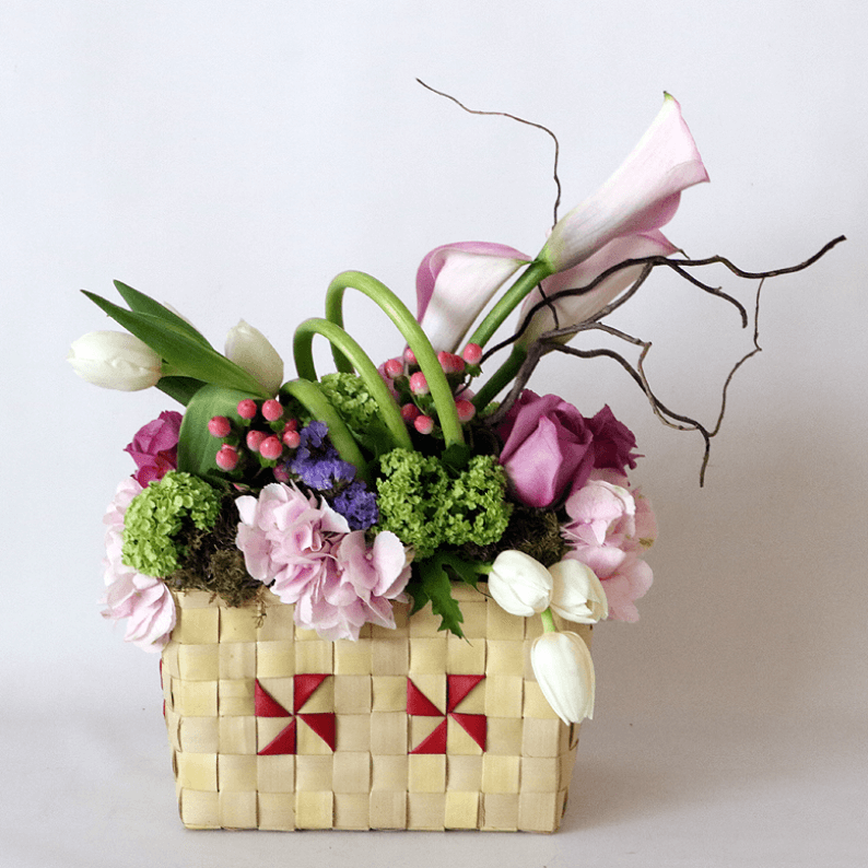 pink hydrangea, pink calla lily, white tulips, purple roses arranged in a basket