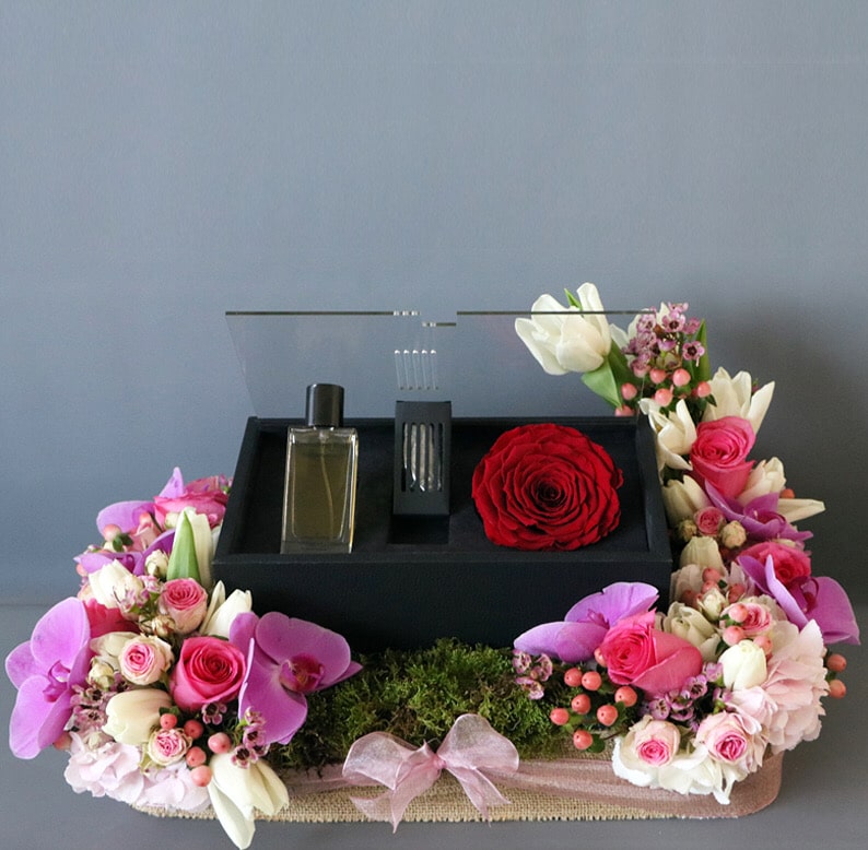 perfume and perfume box in flower arrangement
