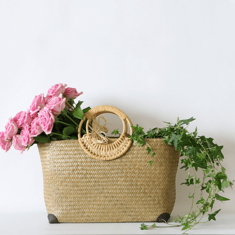rattan basket filled with pink roses and ivy
