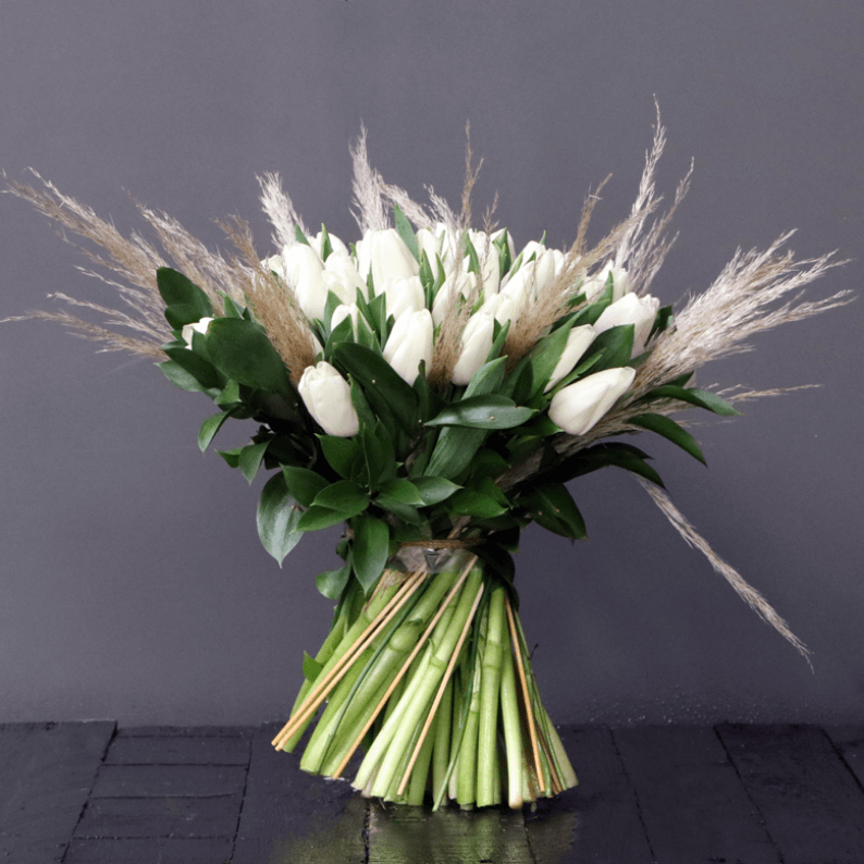white tulips and pampas grass in a bouquet