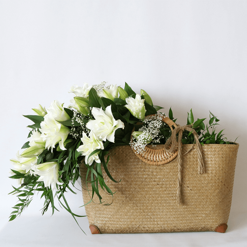 rattan basket filled with rose lily and leaves