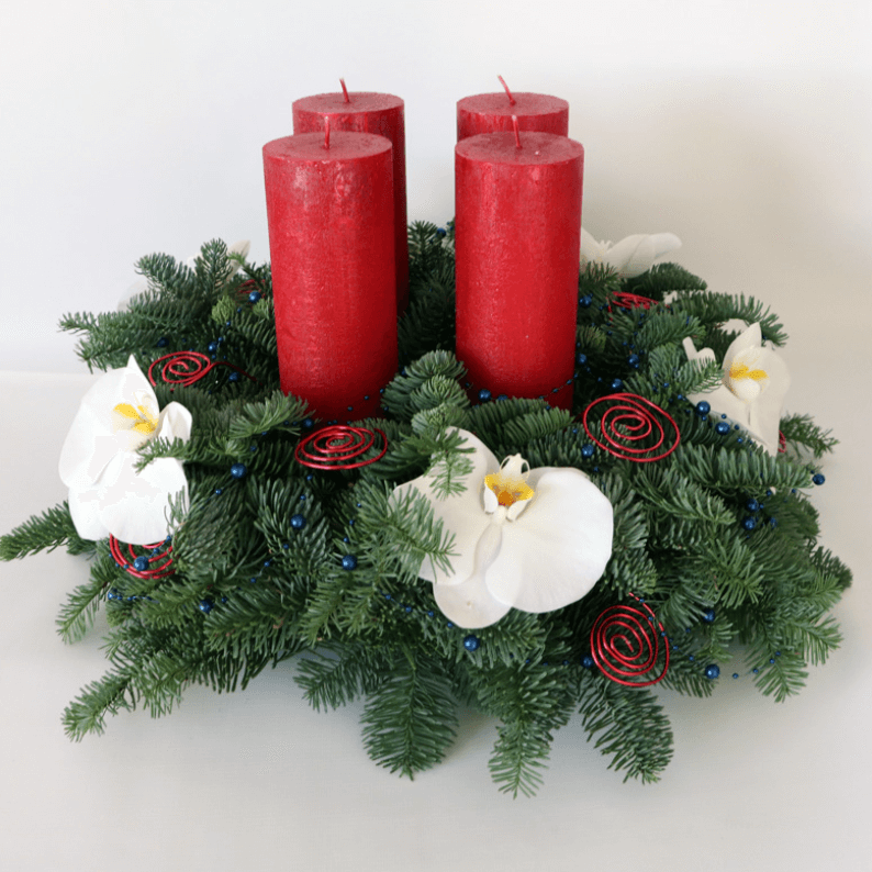 Arrangement with four red candles and orchids