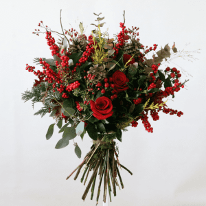berries, red roses and leaves in a bouquet