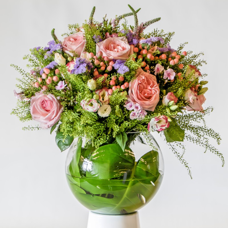 Pink and purple flower bouquet in a glass vase