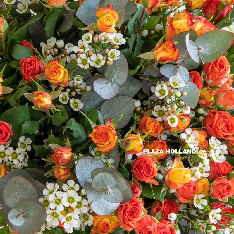 Close up of wax flower and orange spray roses