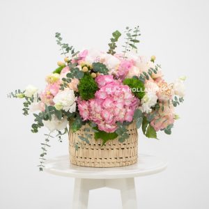 Pink and white flower arrangement in a basket