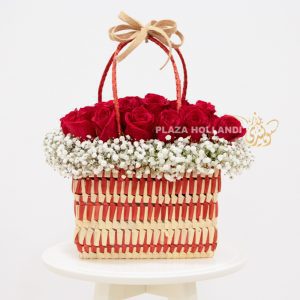 Red and white basket full of roses and gypsophelia flowers