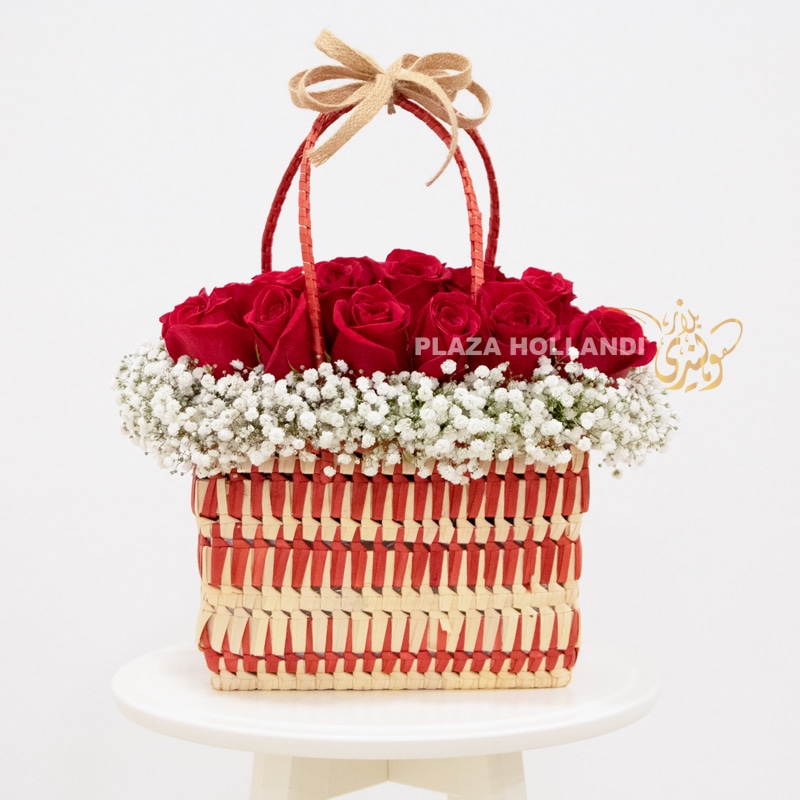Red and white basket full of roses and gypsophelia flowers