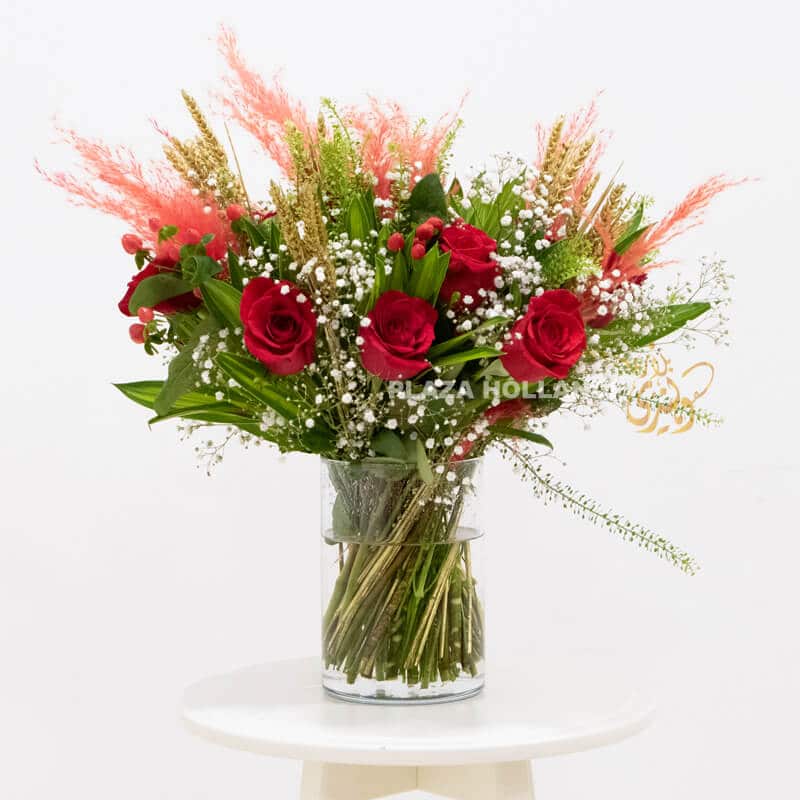 Pampas grass and red rose bouquet of flowers