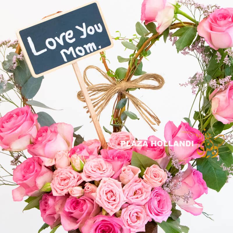 close up of I love you mum sign and pink flowers