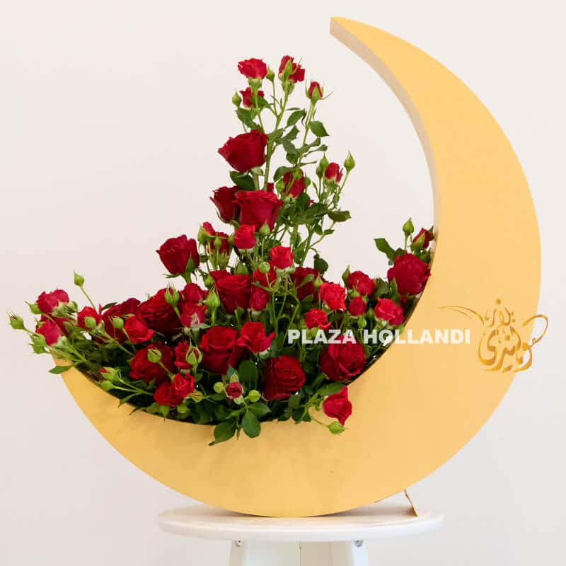 Red roses, spray roses in a gold crescent moon