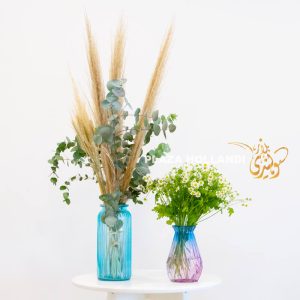 Pampas grass and daisies in vases