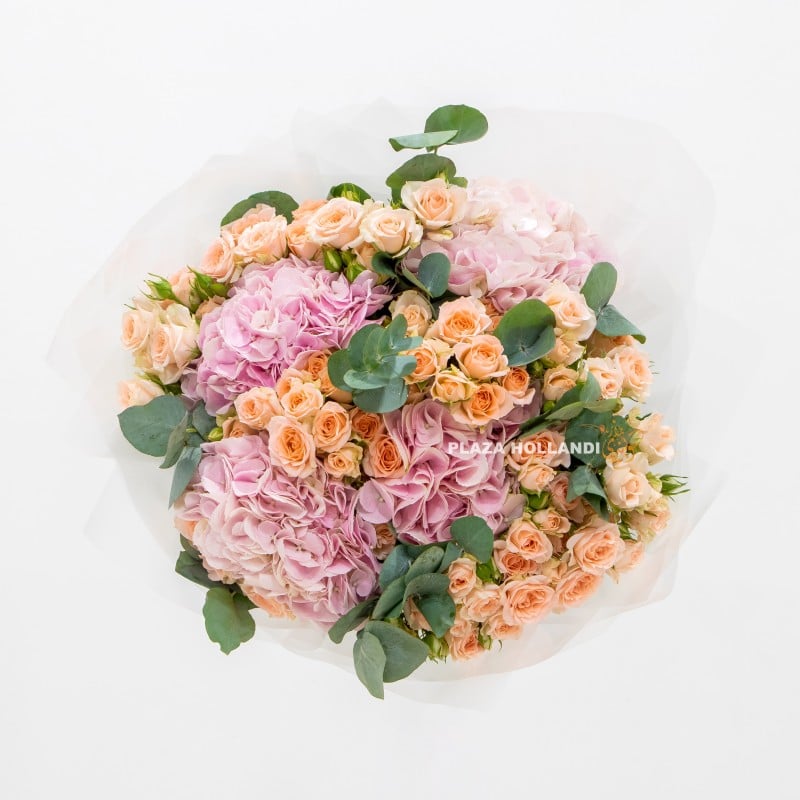 bouquet of flowers of pink hydrangea, peach spray roses and eucalyptus