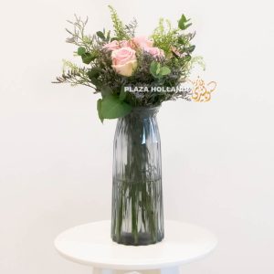 Tall vase with roses and greenery