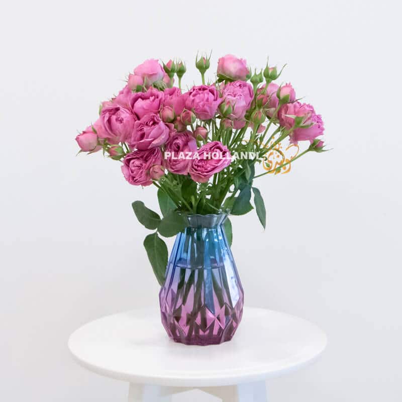 blue vase with purple spray rose flowers