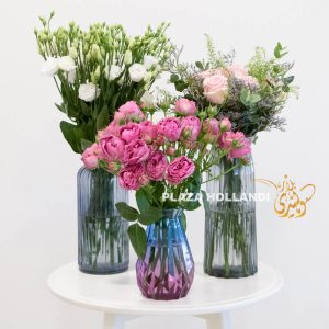 Three vases full of flowers