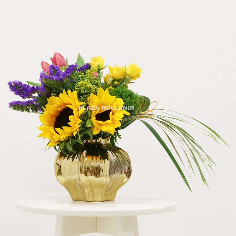 Sunflower flower arrangement with tulips in a gold vase