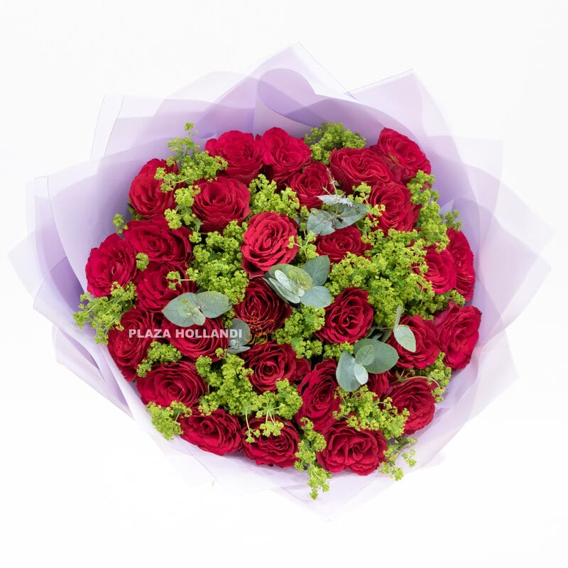 red rose bouquet with greenery and purple paper