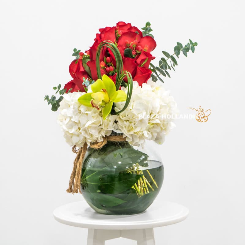 round flower vase with red roses and hydrangea