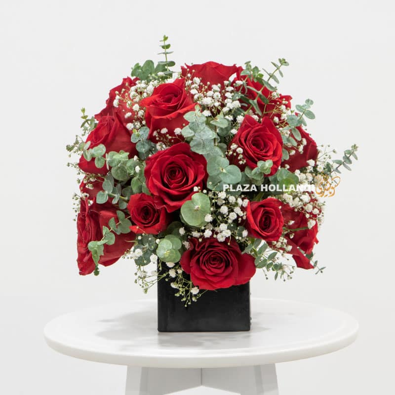 Red and white flower arrangement in a black box