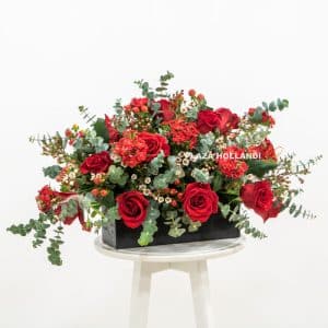 Red roses with eucalyptus in a black box