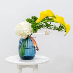Blue vase with white and yellow flowers for fathers day