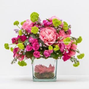 Dark pink peony flower design in a glass vase